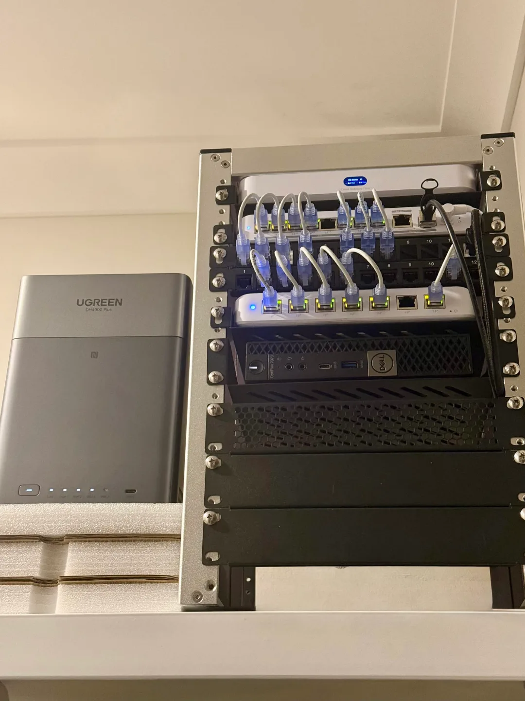 The N5HQ homelab rack — UniFi Cloud Gateway Fibre, patch panel and Flex switch cabled above a Dell OptiPlex 7070 node, with the UGREEN DH4300 Plus NAS alongside.